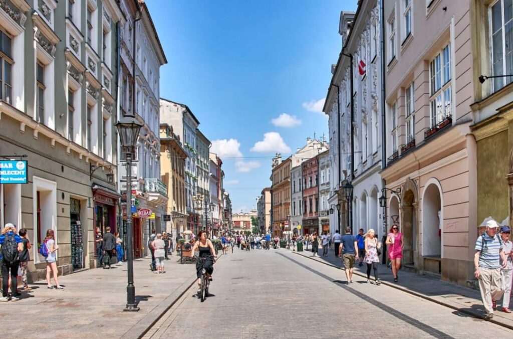 Clean public street with pedestrians in Kraków, Poland