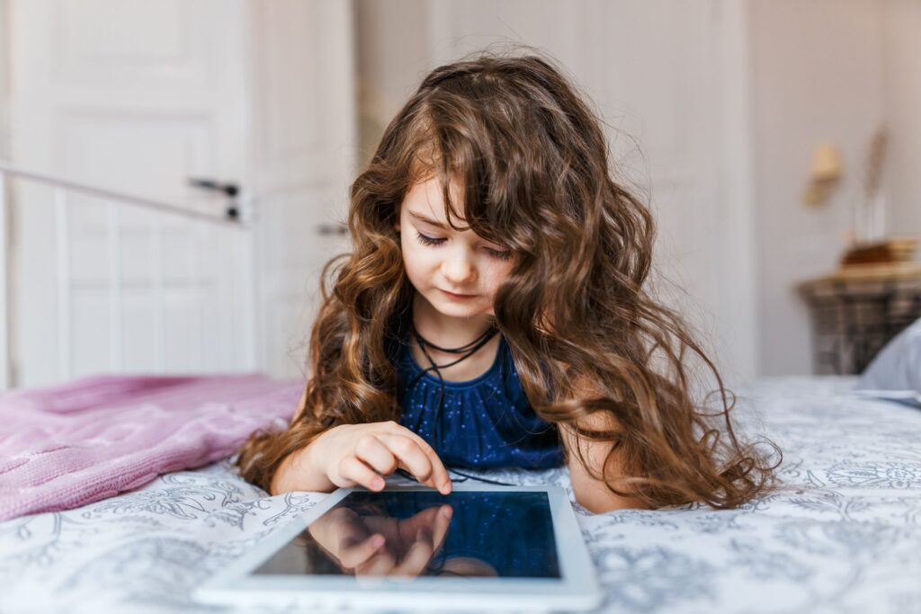 Young girl using a tablet as part of screen time in the digital age